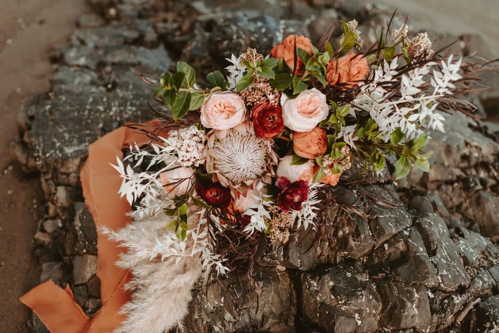 couple adventure session, bridal bouquet, boho bridal bouquet, boho wedding, portland wedding florist, portland wedding flowers, oregon wedding flowers, oregon wedding florist, burnt orange roses, juliet garden roses, peach garden roses, king protea, bleached flowers, dried flowers, pampas grass, wedding photos