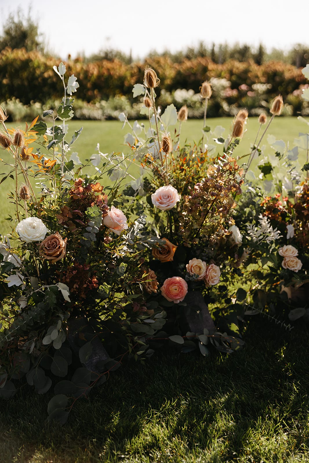 wedding ceremony ground floral installation in warm earth tones at the Orchard Hood River